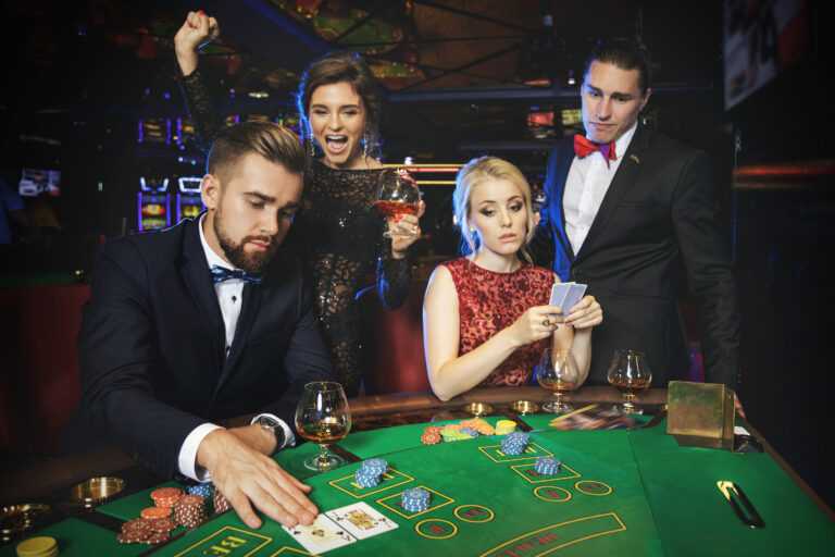 Group of rich people is playing poker in the casino