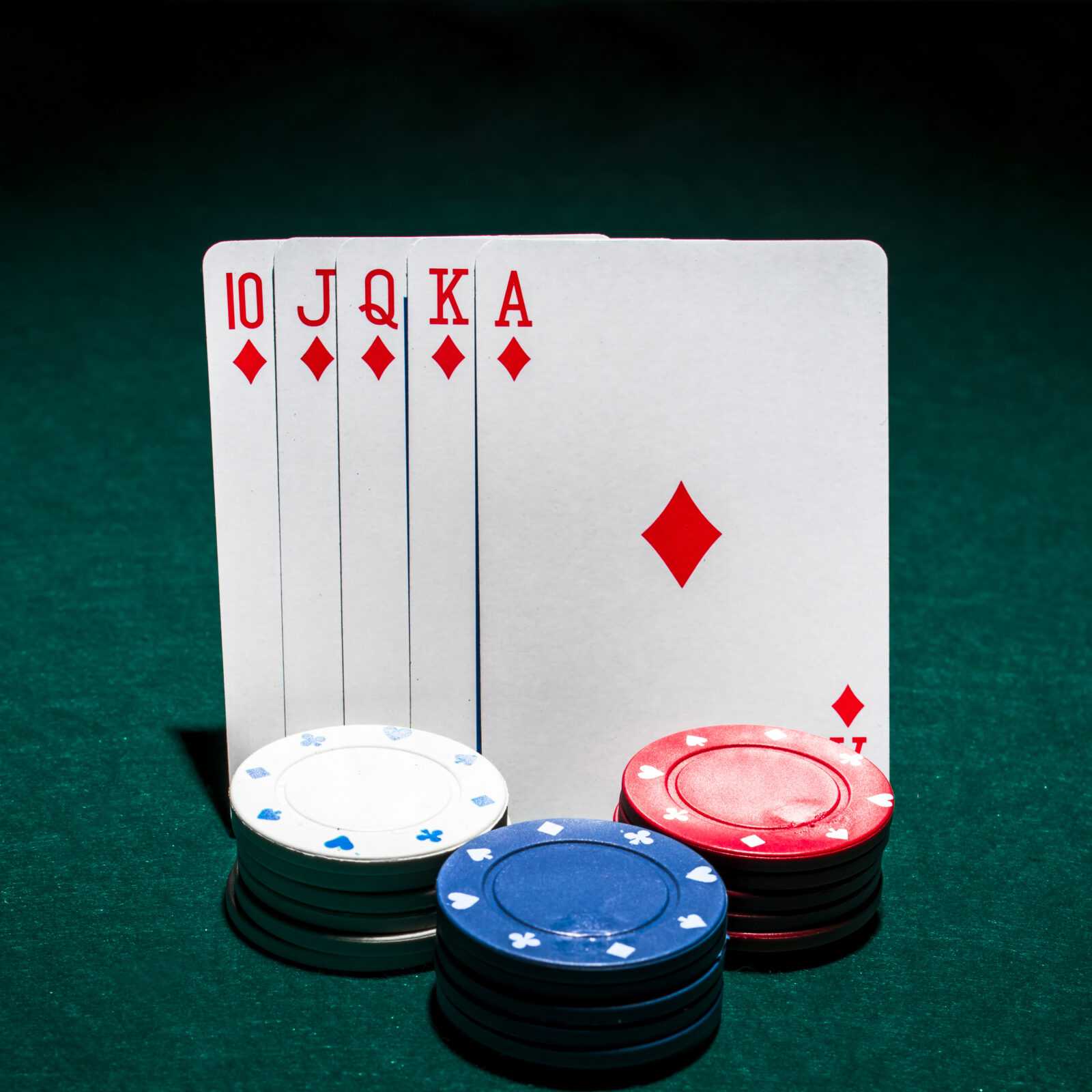 stack-casino-chips-front-royal-flush-playing-card-poker-table