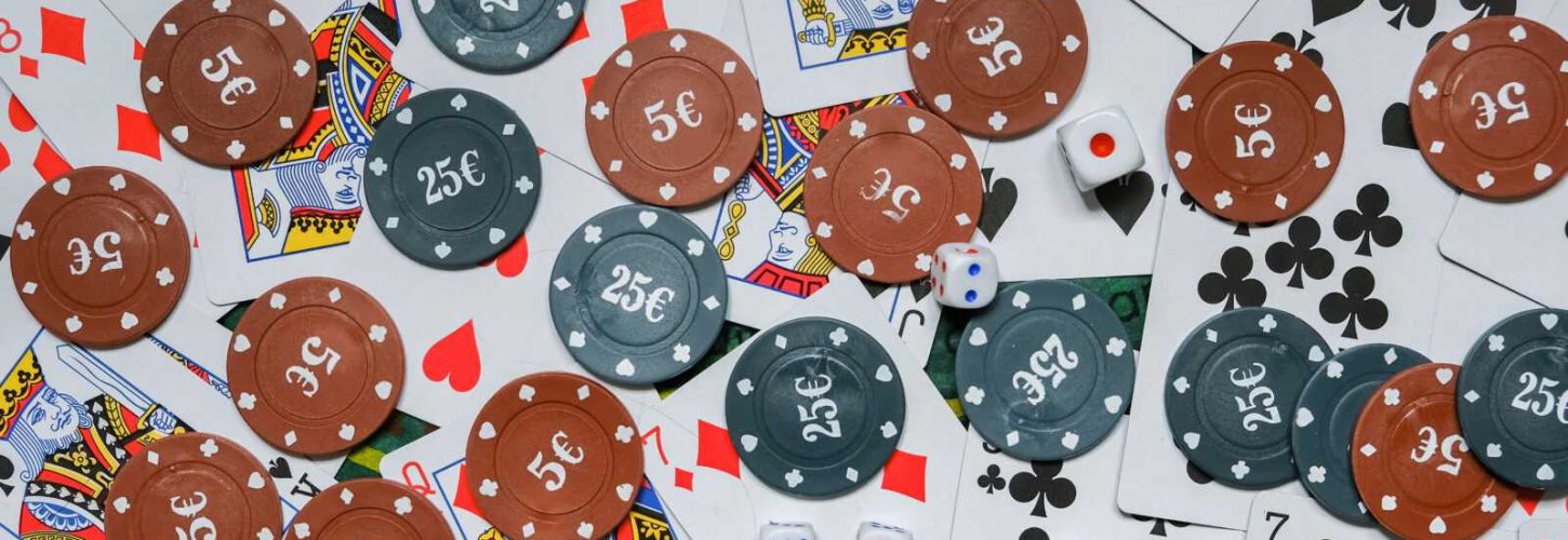 Gambling board game.Cards, chips, roulette.Gaming flat lay. Close-up of a card for playing poker on a gaming table in a casino against a background of chips. Background for the gaming business.